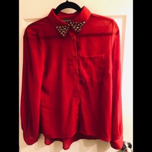 Red studded blouse.